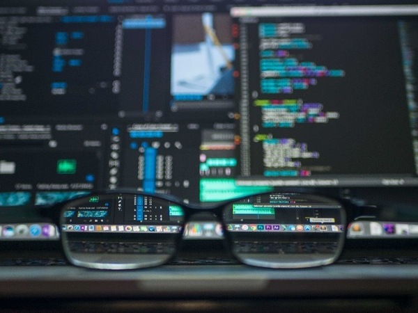 Glasses with coding in the background